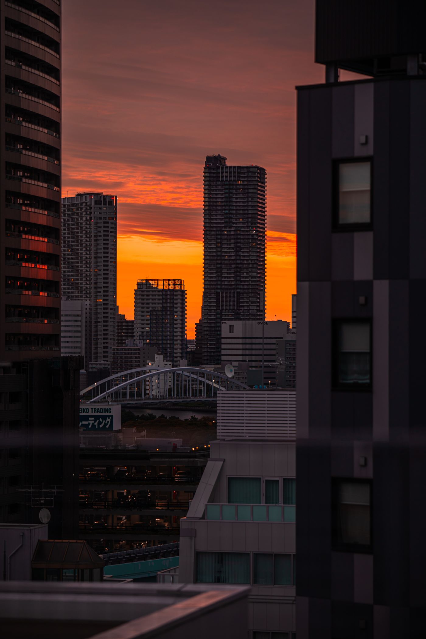 Tokyo towers framed against an orange evening sky
